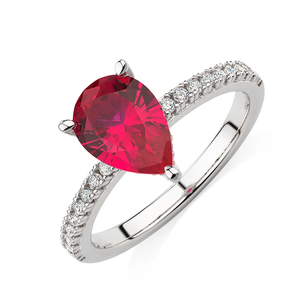 Dress ring with ruby simulant and 0.24 carats* of diamond simulants in sterling silver